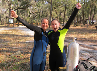 Tallahassee SCUBA Instructor Gabrielle with student Erin celebrate her successful checkout dives to earn her open water certification!